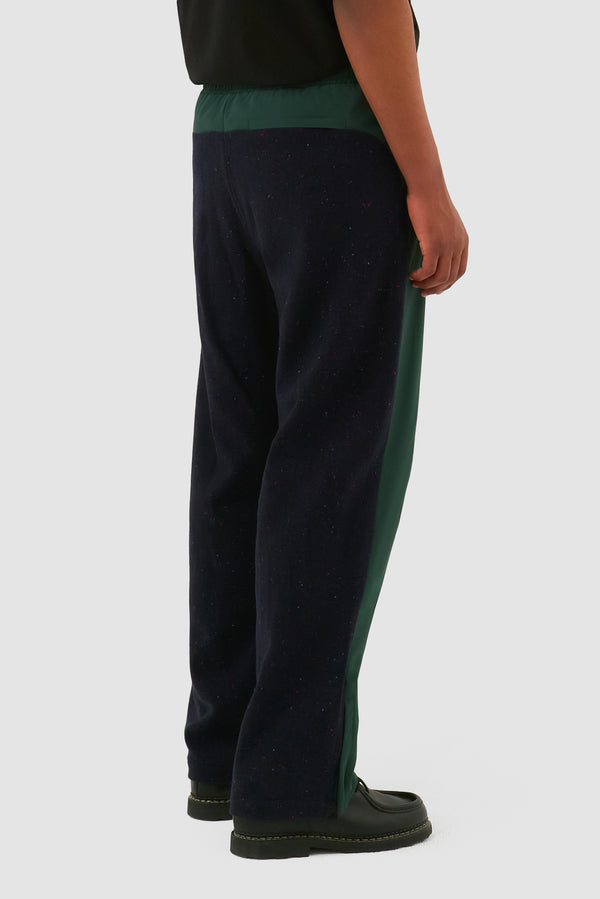 Wool Technical Pants in Green worn by a model, half-body side view