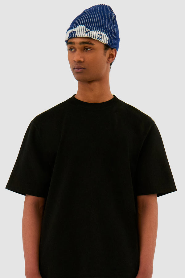 Ribbed Beanie in Navy worn by a model, half-body front view