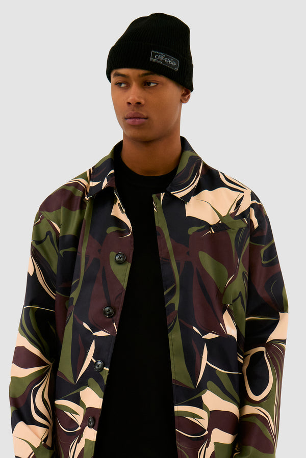 Woven Label Beanie in Black worn by a model, half-body front view