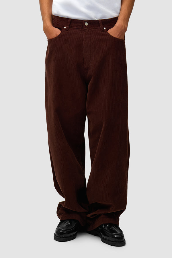 Corduroy Pants in Brown worn by a model, half-body front view