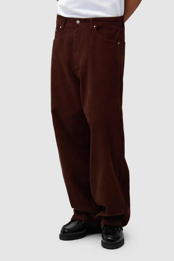 Corduroy Pants in Brown worn by a model, half-body back view