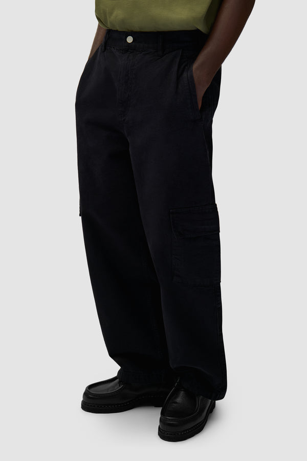Low Cargo Pants in Black worn by a model, half-body back view