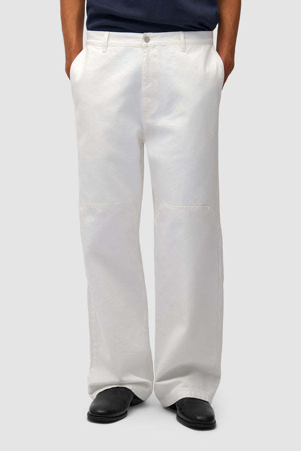 Round Knee Cut Pants in White worn by a model, half-body front view