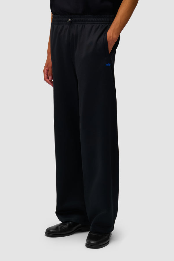 Carded Tracksuit Bottom in Black worn by a model, half-body back view