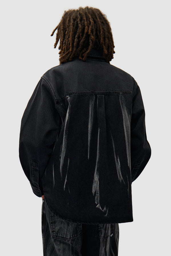 Denim Shirt in Black Denim worn by a model, half-body back view