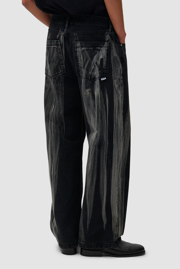 Washed Jeans Pants in Black Denim worn by a model, half-body back view