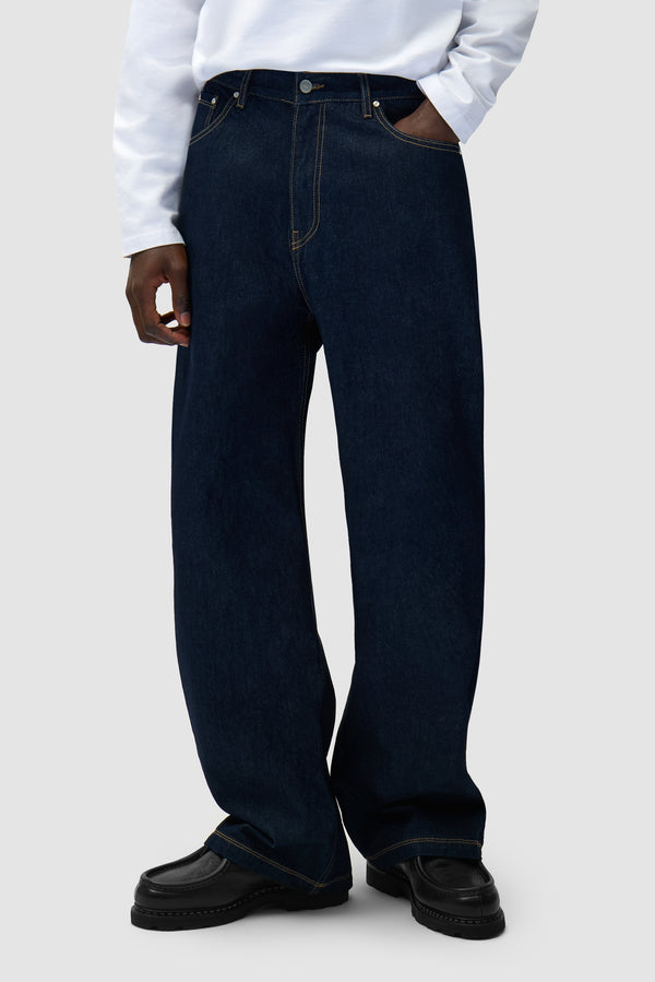 Basic Jeans Pants in Raw Denim worn by a model, half-body front view