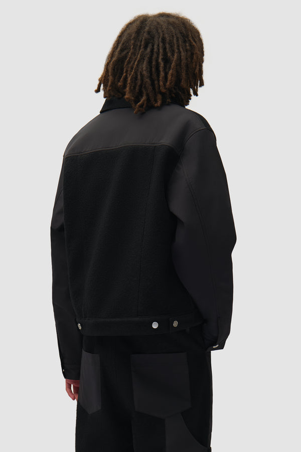 Nylon/Wool Combo Jacket in Black worn by a model, half-body back view
