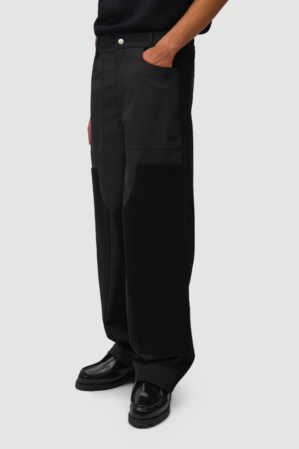 Nylon/Wool Combo Pants in Black worn by a model, half-body side view
