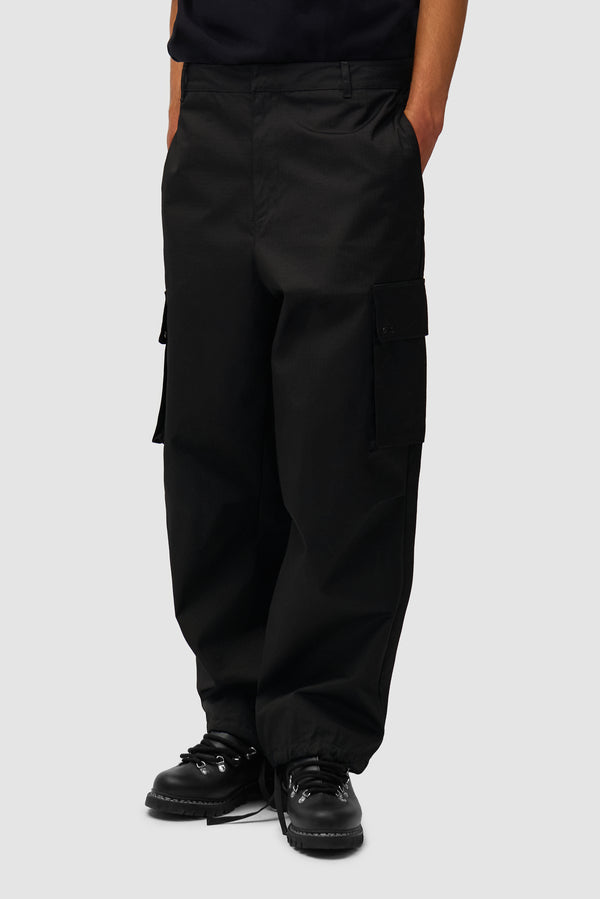 Waxed Ripstop Pants in Black worn by a model, half-body front view