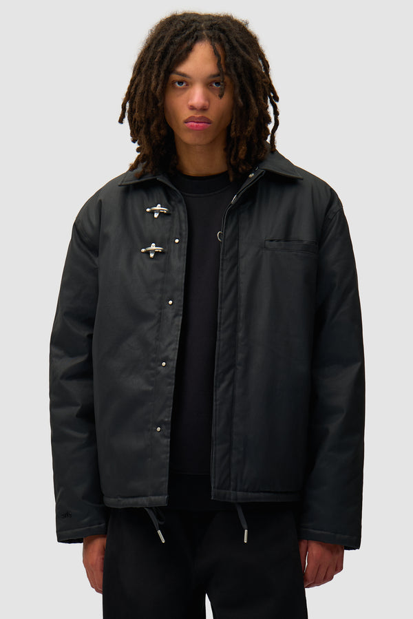 Fireman Jacket in Black worn by a model, half-body front view