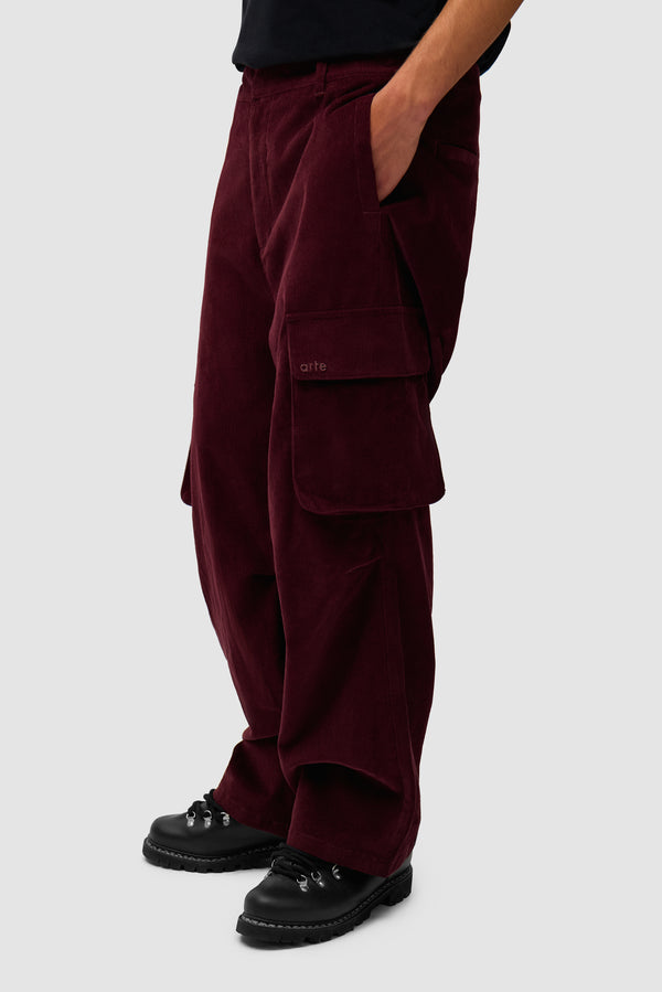 Corduroy Cargo Pants in Bordeaux worn by a model, half-body side view