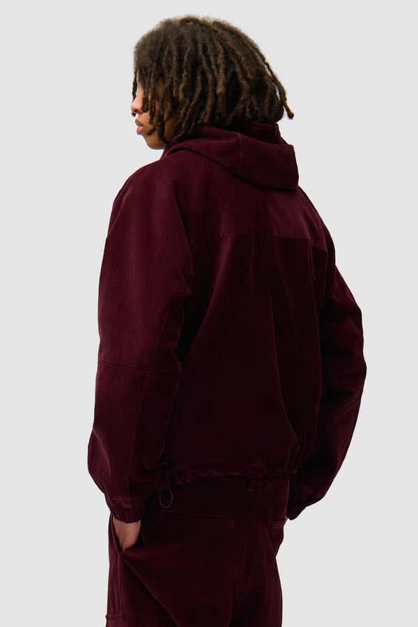 Corduroy Technical Jacket in Bordeaux worn by a model, half-body back view