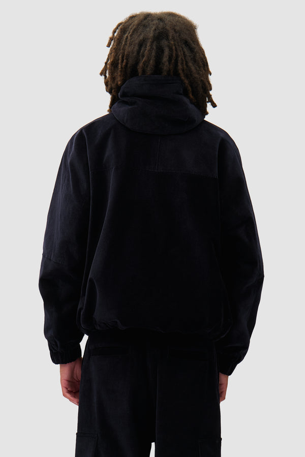 Corduroy Technical Jacket in Navy worn by a model, half-body back view