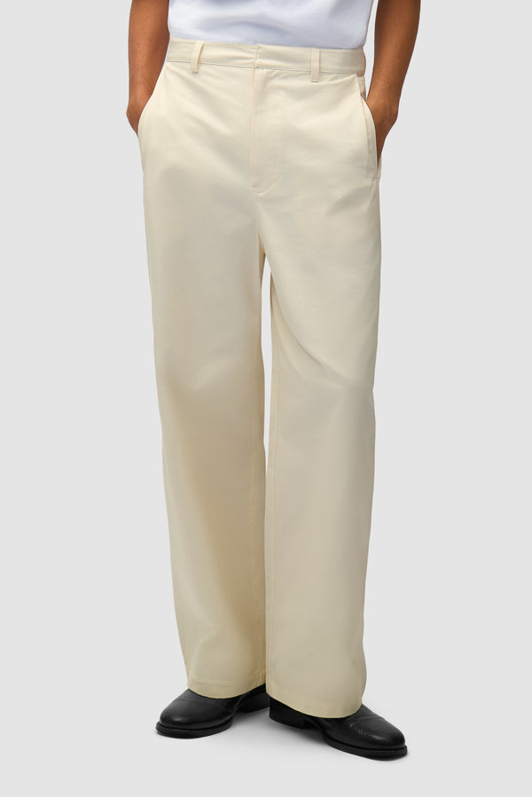 Dress Pants in Cream worn by a model, half-body front view