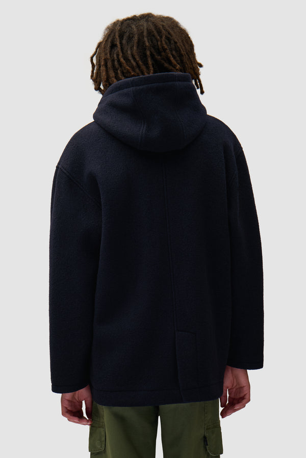 Duffel Coat in Navy worn by a model, half-body back view