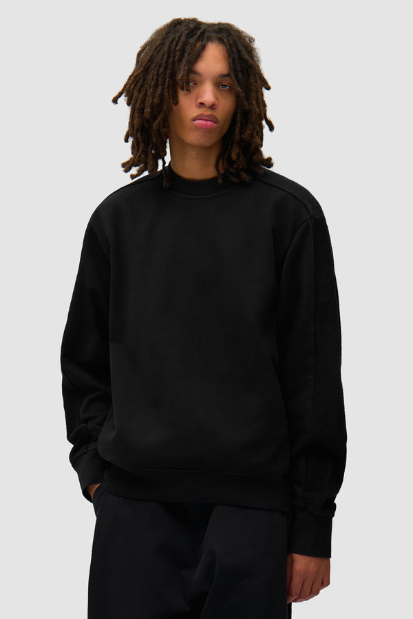 In/Out Crewneck in Black worn by a model, half-body front view
