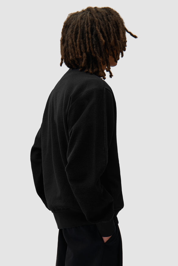 In/Out Crewneck in Black worn by a model, half-body back view