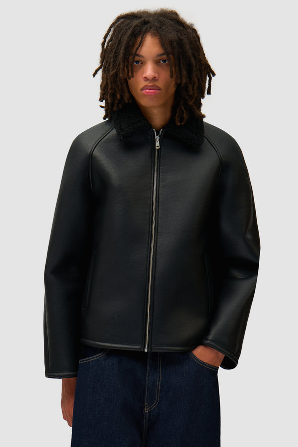 Shearling Jacket in Black worn by a model, half-body front view
