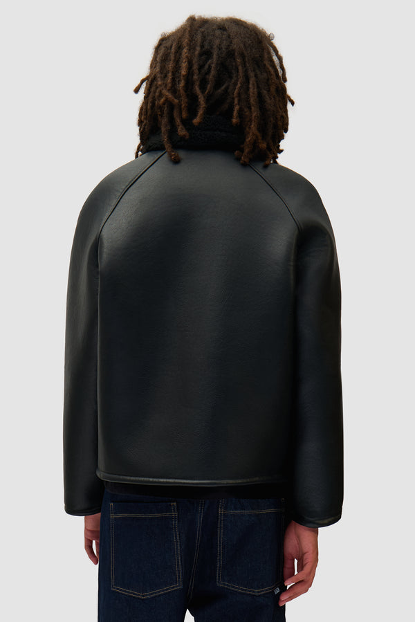 Shearling Jacket in Black worn by a model, half-body back view