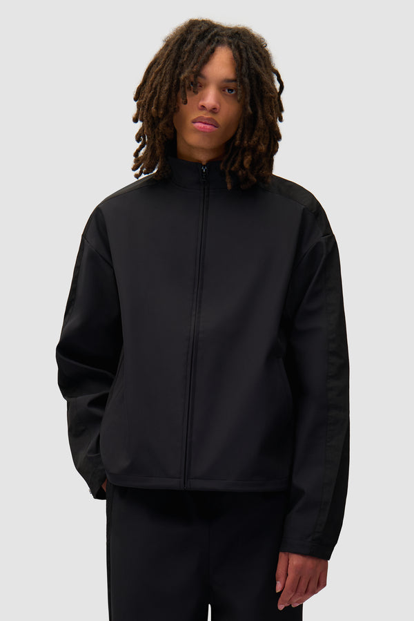 Nylon Track Jacket in Black worn by a model, half-body front view