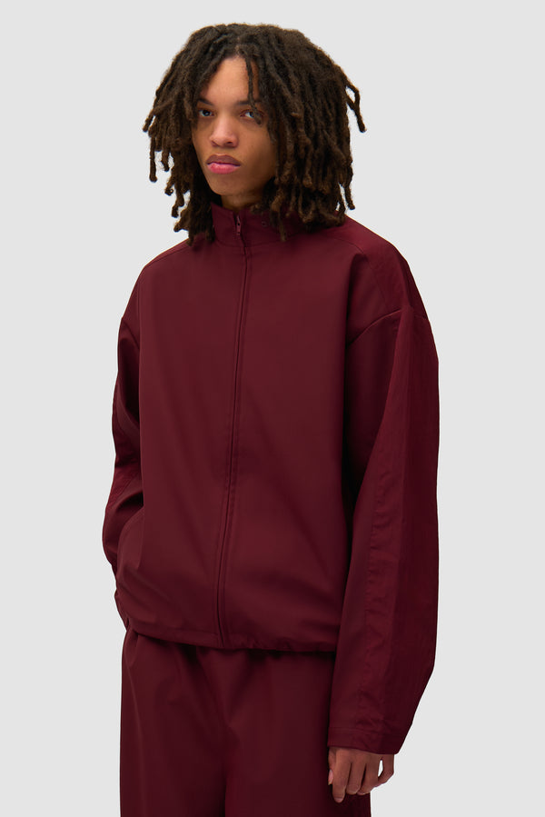 Nylon Track Jacket in Bordeaux worn by a model, half-body front view