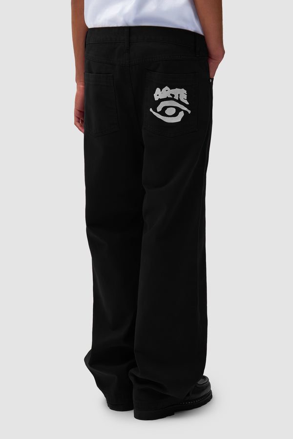 Back Pocket Graphic Pants in Black worn by a model, half-body back view
