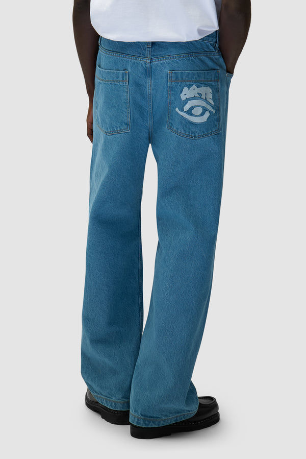 Back Pocket Graphic Pants in Bleach worn by a model, half-body side view