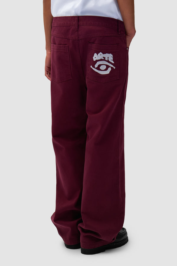 Back Pocket Graphic Pants in Bordeaux worn by a model, half-body back view