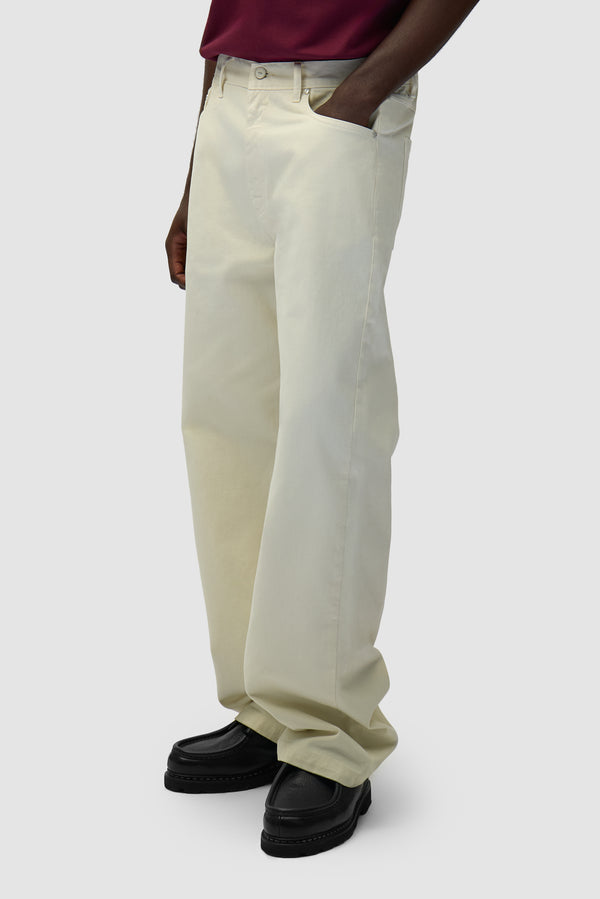 Back Pocket Graphic Pants in Cream worn by a model, half-body back view