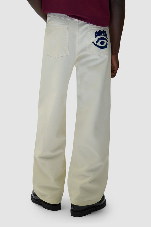 Back Pocket Graphic Pants in Cream worn by a model, half-body front view