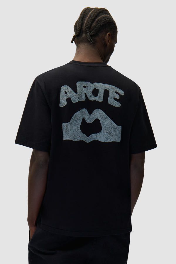 Diels Scribble T-shirt in Black worn by a model, half-body back view