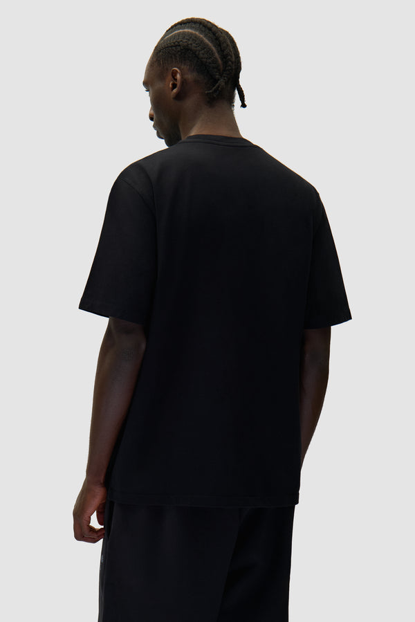Arte Heart T-shirt in Black worn by a model, half-body back view
