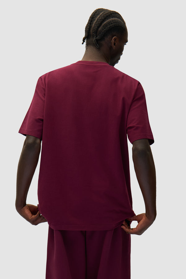 Arte Heart T-shirt in Bordeaux worn by a model, half-body back view