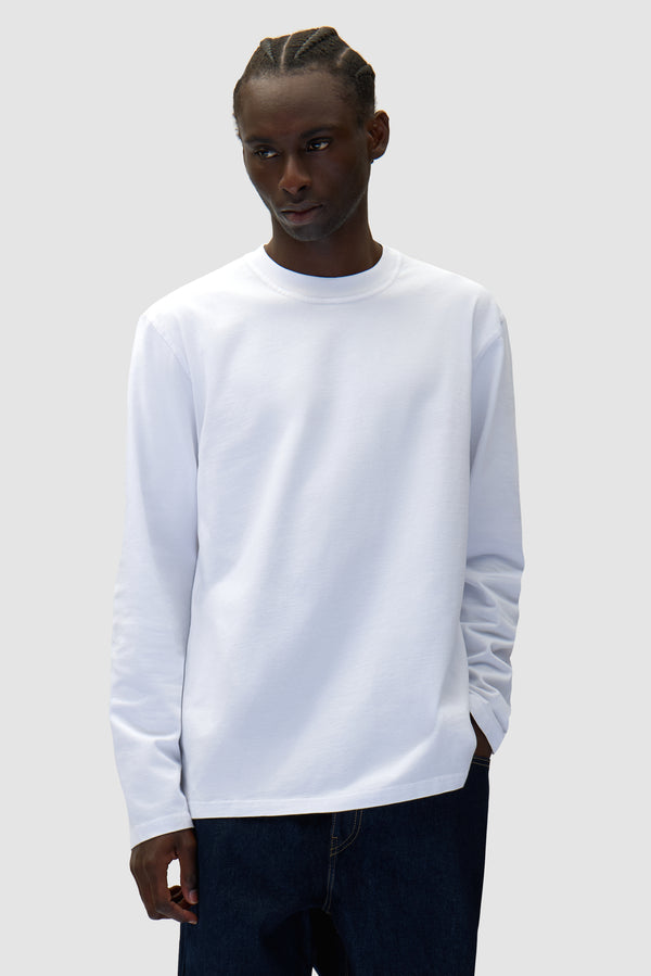 Diels Scribble Longsleeve in White worn by a model, half-body front view
