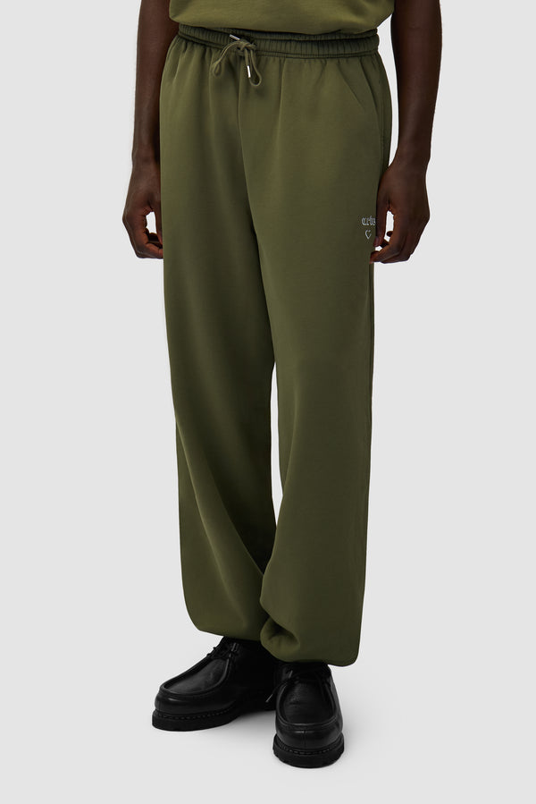 Arte Heart Pants in Green worn by a model, half-body back view