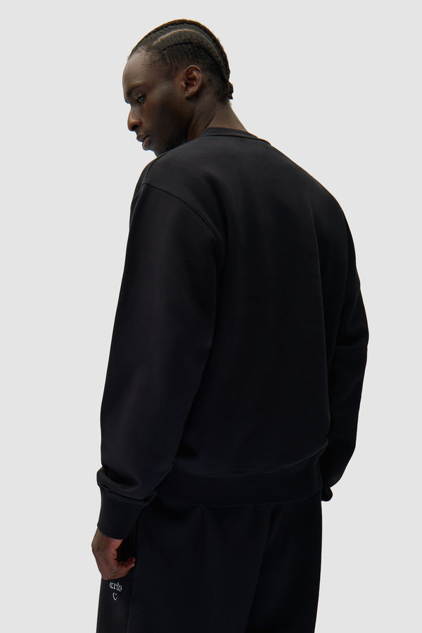 Arte Heart Crewneck in Black worn by a model, half-body back view