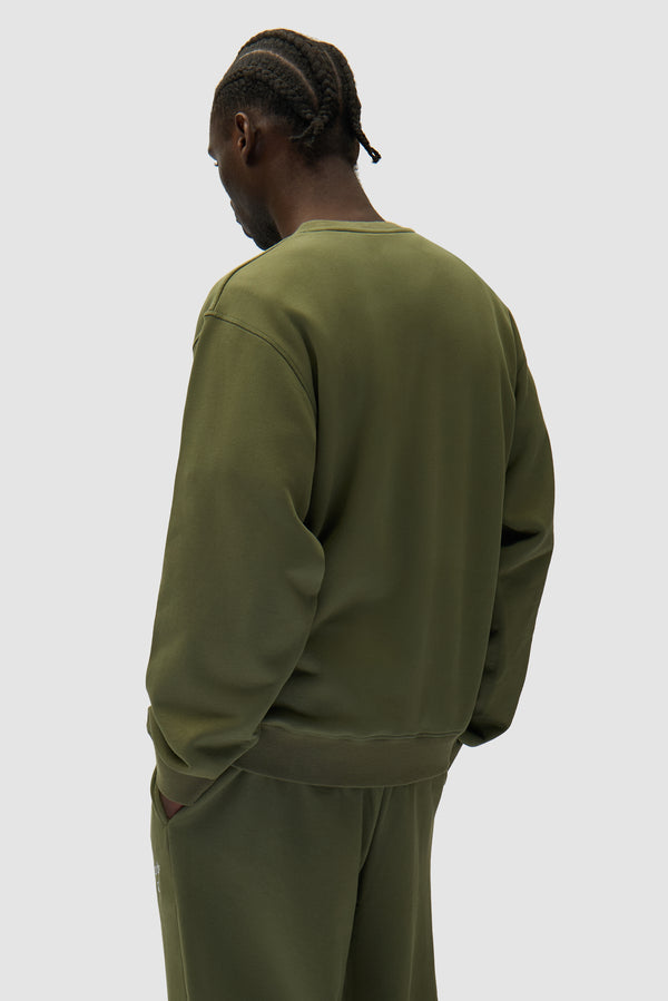 Arte Heart Crewneck in Green worn by a model, half-body back view