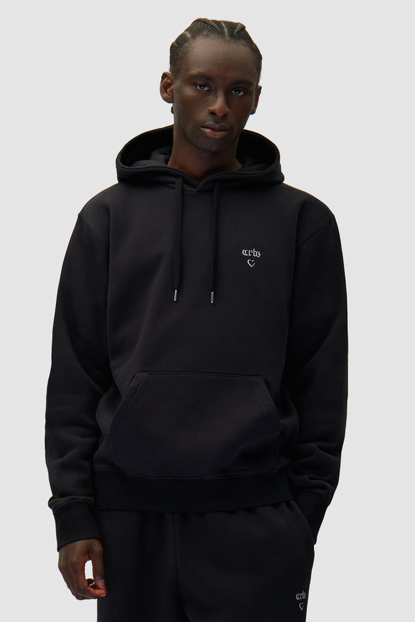 Arte Heart Hoodie in Black worn by a model, half-body front view