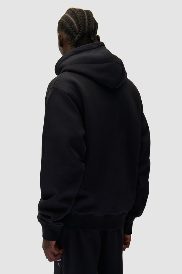 Arte Heart Hoodie in Black worn by a model, half-body back view