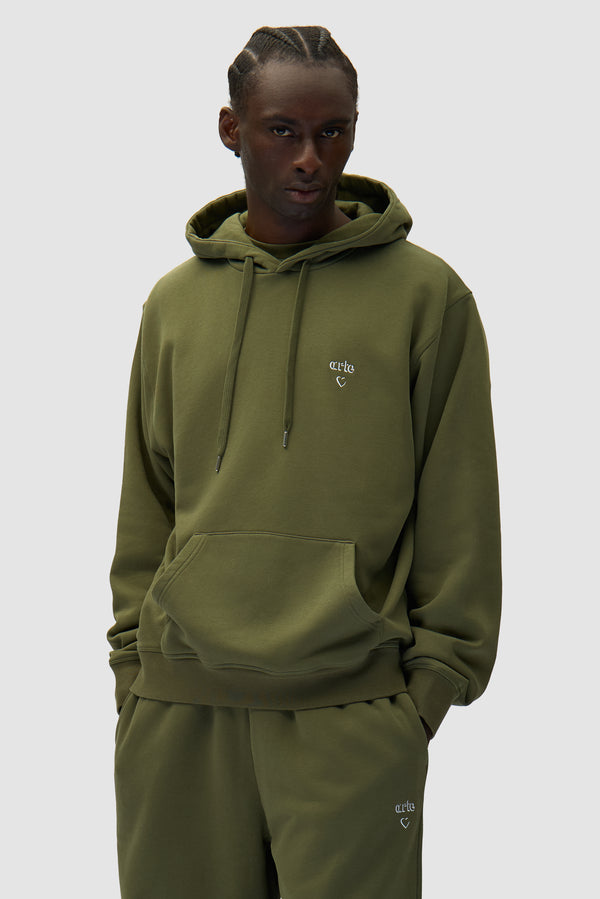 Arte Heart Hoodie in Green worn by a model, half-body front view