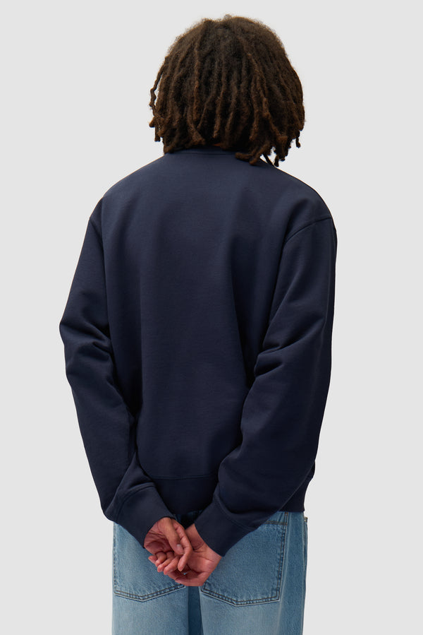Arte Blocks Crewneck in Navy worn by a model, half-body back view