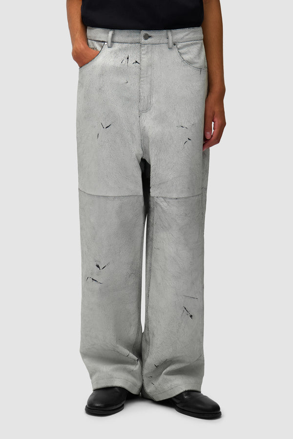 Cracked Leather Pants in White worn by a model, half-body front view