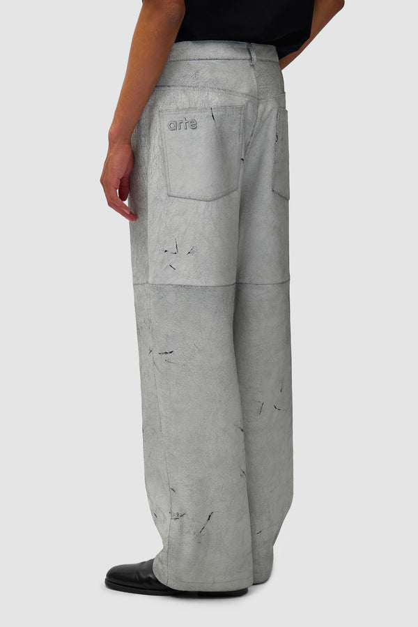 Cracked Leather Pants in White worn by a model, half-body back view