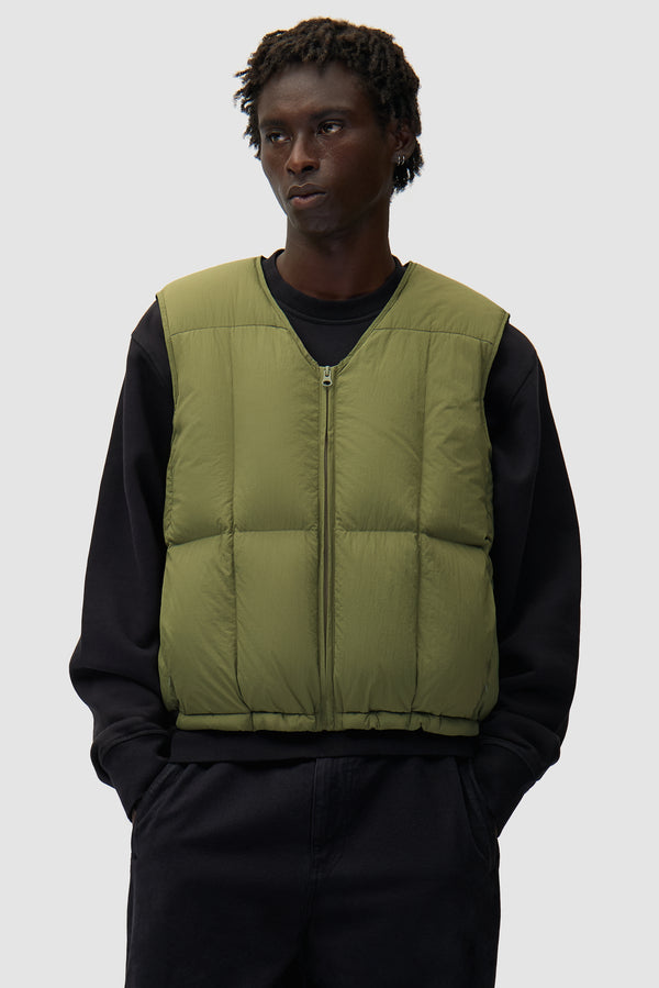 Puffer Vest in Green worn by a model, half-body front view