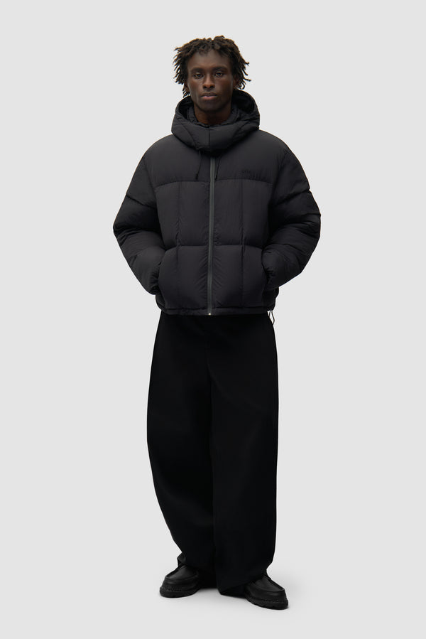 Special Cuts Puffer Jacket in Black worn by a model, full-body front view