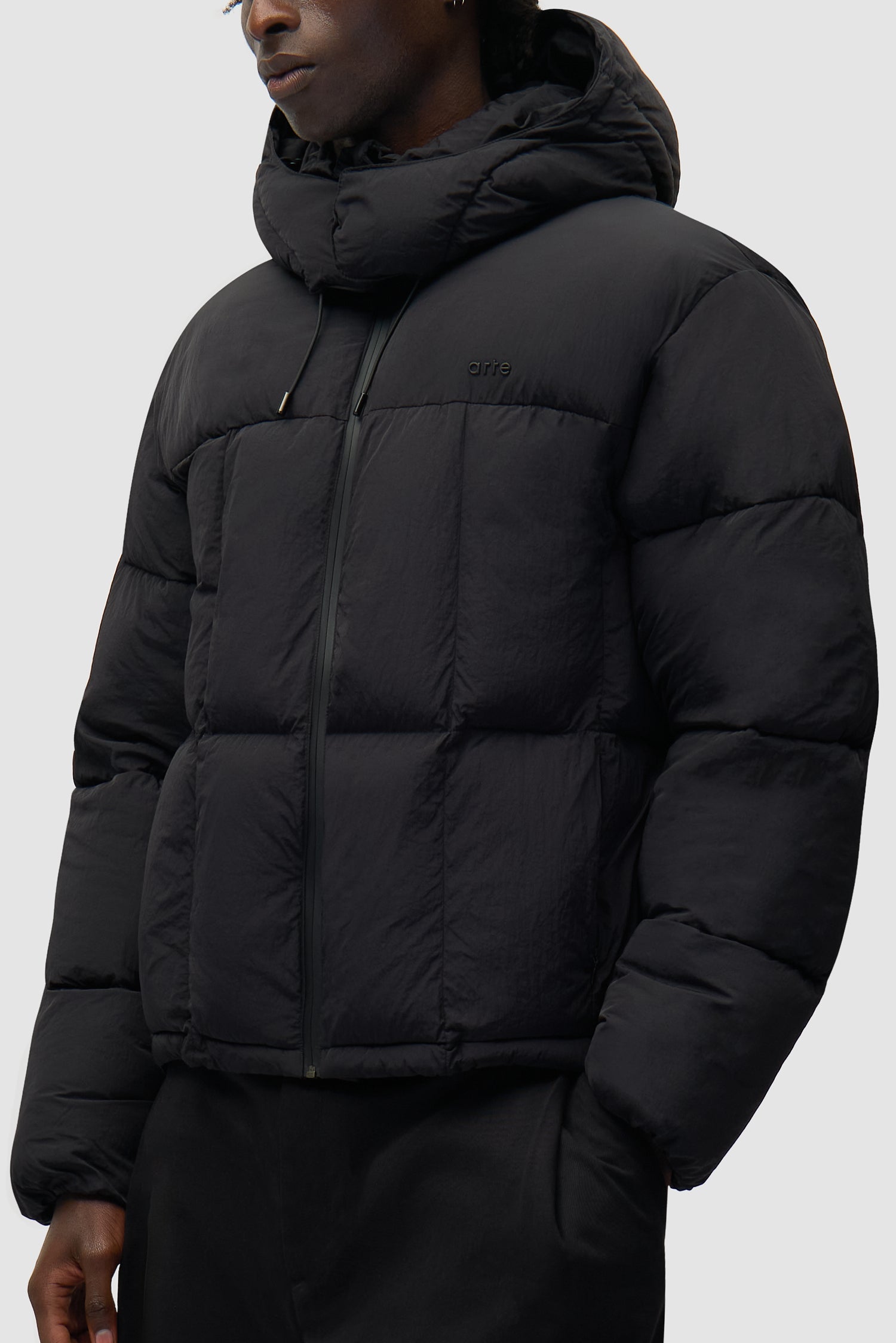 Special Cuts Puffer Jacket in Black worn by a model, half-body side