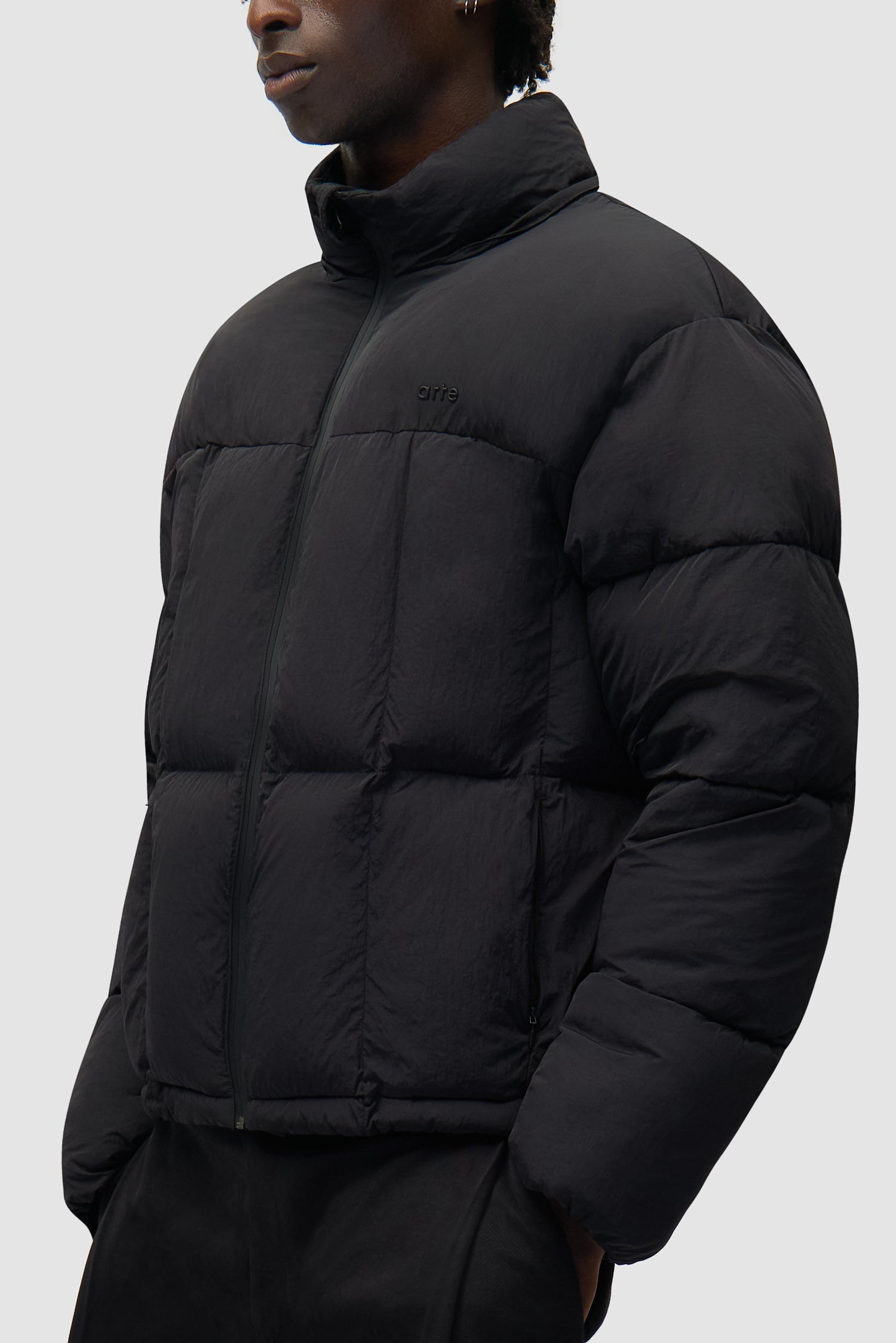Special Cuts Puffer Jacket in Black worn by a model, half-body side