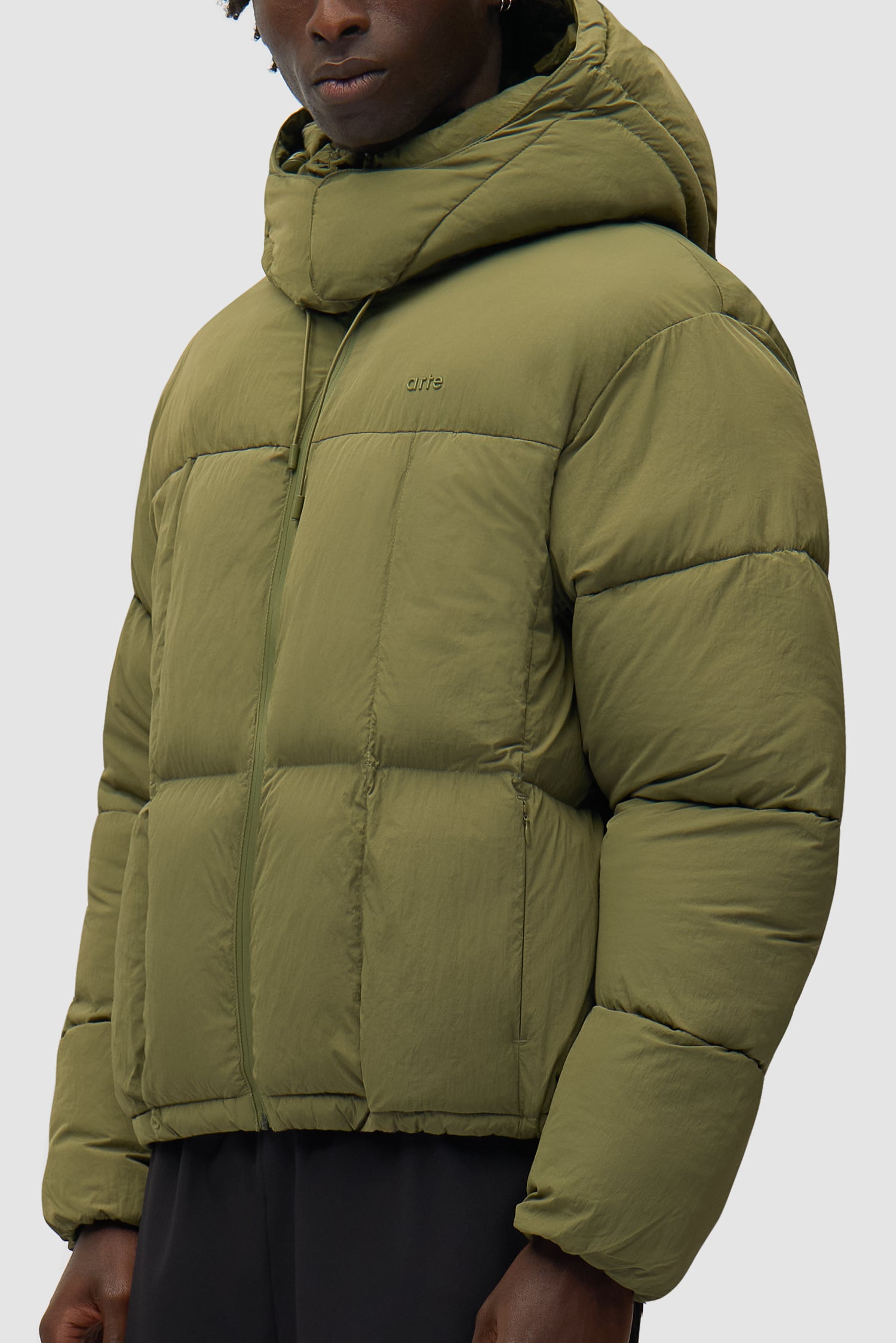 Special Cuts Puffer Jacket in Green worn by a model, half-body side