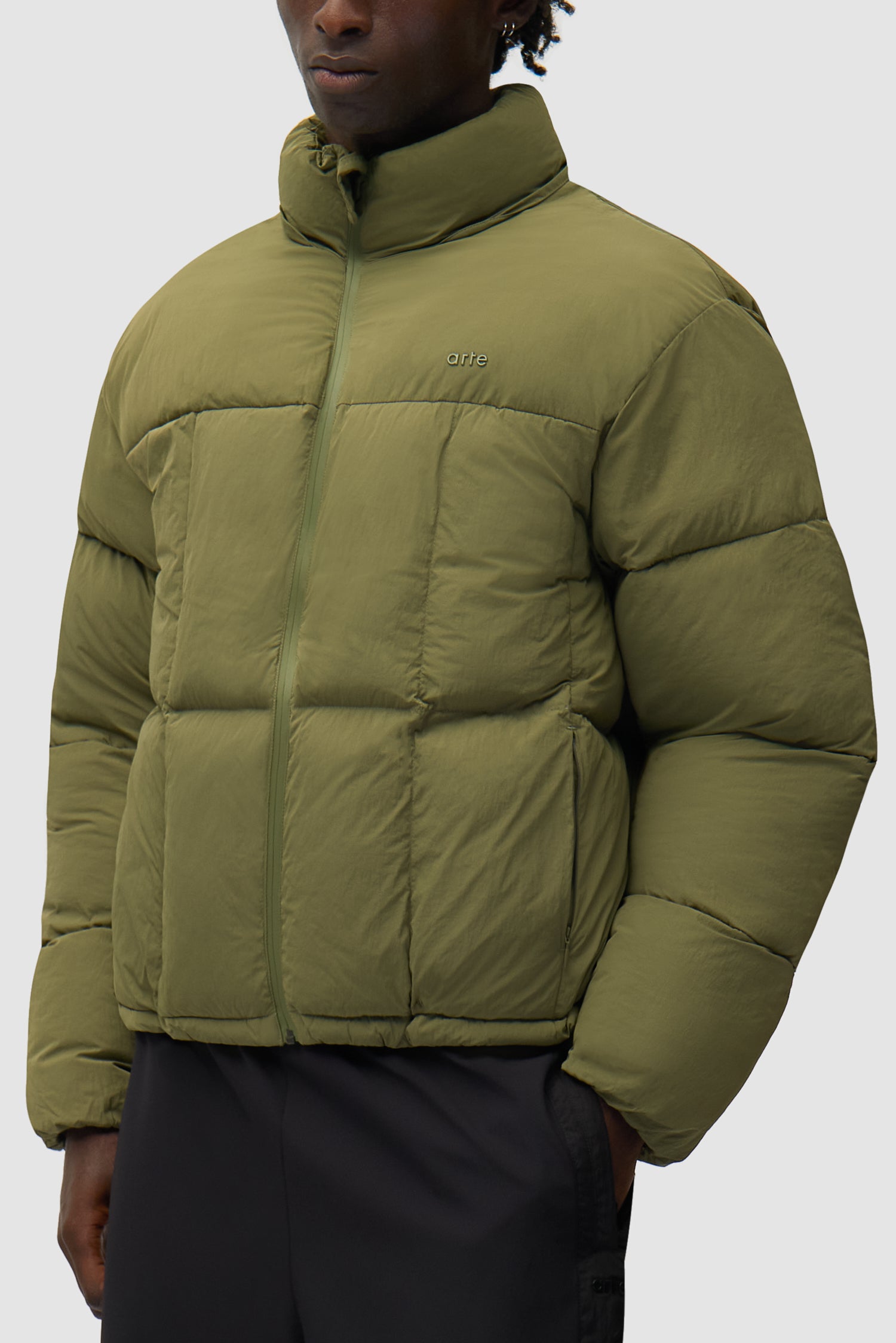 Special Cuts Puffer Jacket in Green worn by a model, half-body side